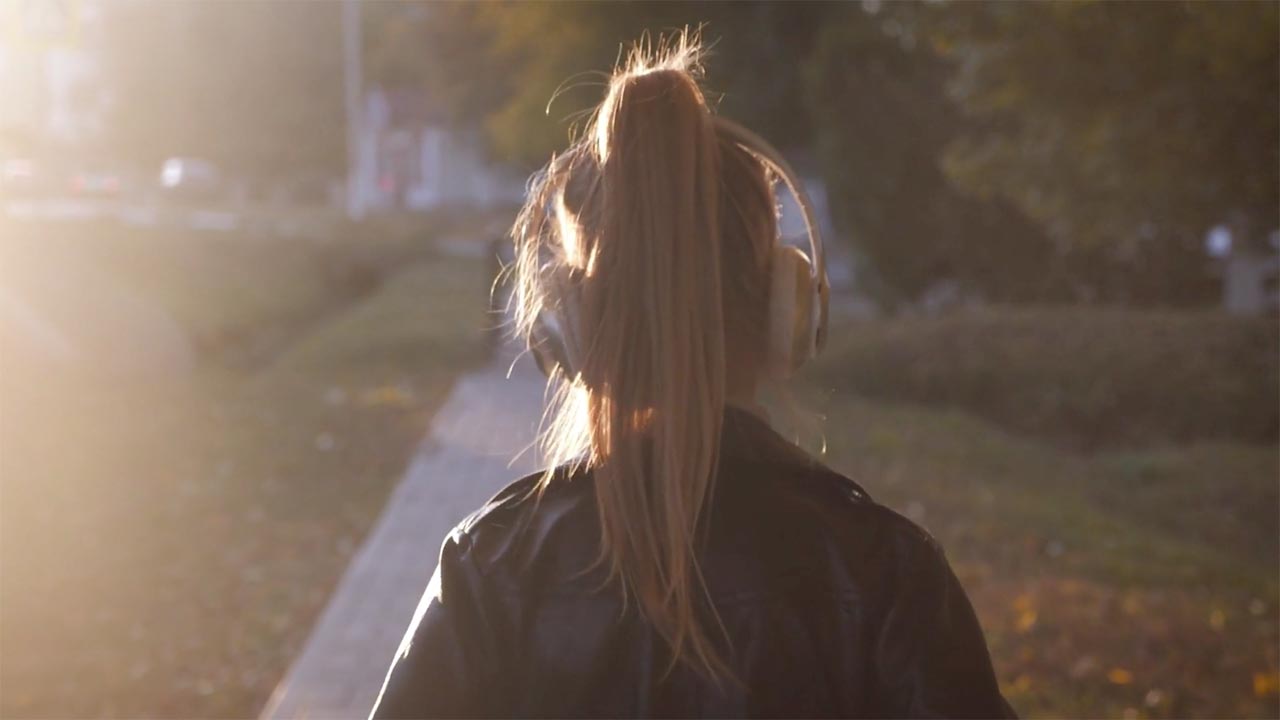 Girl Listening to Romantic Songs while walking in the park